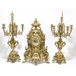 FRANZ HERMLE & SONS; a modern gilt metal three-piece clock garniture, in a Rococo style, the clock