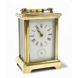 A late 19th century French brass cased carriage clock, the enamelled dial set with Roman numerals