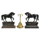 Two cast iron doorstops modelled as horses, height 27cm, and a brass doorstop with weighted base (