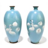 A pair of Japanese Meiji period wireless cloisonné vases of ovoid form decorated with cranes and