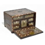 A 17th/18th century Indo-Portuguese inlaid hardwood table top cabinet with fall enclosing an