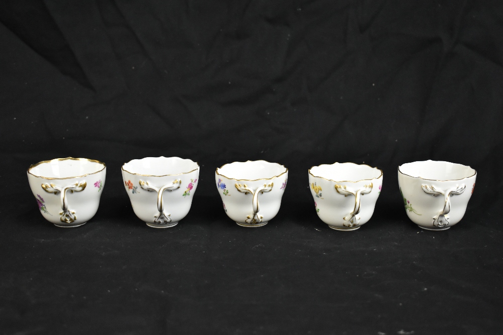 MEISSEN; a harlequin set of five porcelain cups and saucers, each decorated with floral sprigs under - Image 6 of 16