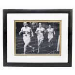 A signed black and white print of Roger Bannister, Christopher Chataway and Chris Brasher, 18 x 24.