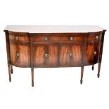 A reproduction mahogany sideboard, with three drawers above four cupboard doors on moulded and