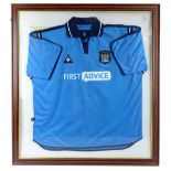 MANCHESTER CITY; a framed autographed Le Coq Sportif 2002-2003 home shirt, bearing various