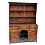 ***WITHDRAWN*** A George III oak dresser with associated stained pine boarded rack above an