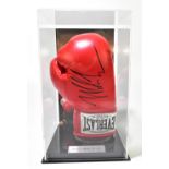 MIKE TYSON; an autographed Everlast right handed boxing glove, fitted in perspex case and stand,