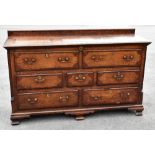 A George III oak and mahogany crossbanded Lancashire mule chest, with hinged top above two dummy
