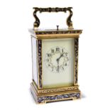 An early 20th century French brass and champlevé enamel decorated repeating carriage clock with