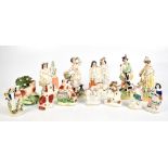 A collection of mostly 19th century Staffordshire figures comprising a pair of Highland figures, the