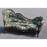 A Victorian carved walnut chaise longue, upholstered with William Morris and Co style floral