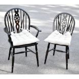 A set of eight stained beech wheelback Windsor type dining chairs, including two with arms, with