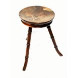 A stool with dished seat and inlaid initials on bamboo form splayed supports. Additional