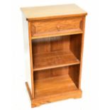 FOXMAN; a golden oak dwarf open bookcase, with drawer above two shelves, on plinth base, the right