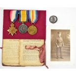 A WWI medal trio awarded to 1632 Pte. R. Bowers Manchester Regiment with Empire badge, photograph