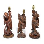 Three 20th century Chinese rootwood table lamps representing deities, two with associated bases,