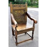 An 18th century and later oak wainscot chair with carved decoration to back and apron on stretchered