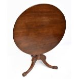 A George III oak tilt-top tripod table, raised on outswept supports, diameter of top 82cm, height