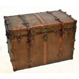 A 19th century leather and brass bound canvas travelling trunk of large proportions, with leather