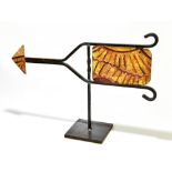 A modern painted metal weather vane point, raised on metal plinth base, height 40cm, width 58cm.