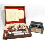 Two WWII incendiary bombs fitted in stained mahogany case with instructions and diagram of