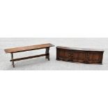 A stained oak hall bench, with rectangular top on standard end supports, height 46cm, width 137cm,