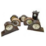Six early 20th century oak cased mantel clocks including a Smiths Enfield example with applied