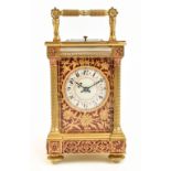 A gilt brass eight day hour repeating carriage clock, the white enamel dial set with Arabic numerals