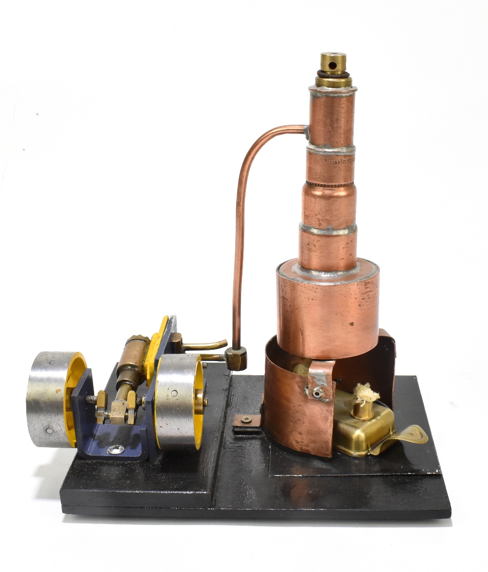 A contemporary scratch built steam engine, with copper chimney, raised on a black painted wooden