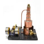 A contemporary scratch built steam engine, with copper chimney, raised on a black painted wooden