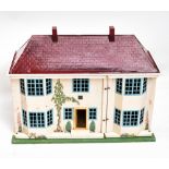 A painted wood and printed metal doll's house, modelled as a double bay fronted 1930s home, with red