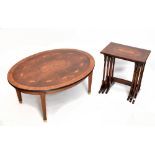 A reproduction marquetry and crossbanded oval coffee table on tapered square section supports,