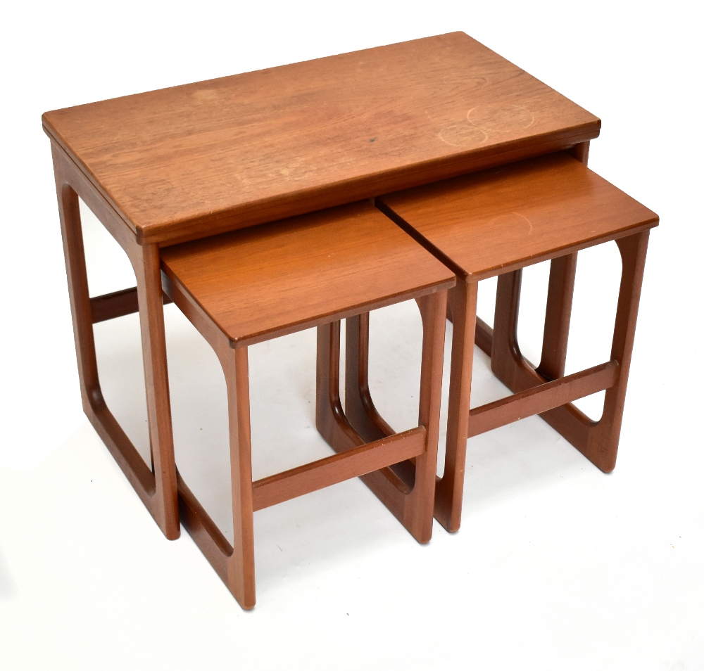 A mid-century teak nest of three occasional tables, the larger rectangular table with a swivel
