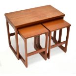 A mid-century teak nest of three occasional tables, the larger rectangular table with a swivel