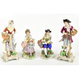 SITZENDORF; two pairs of porcelain figures including a seated male and female surrounded with floral