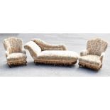 A Victorian three-piece lounge suite comprising chaise longue, raised on turned bun feet, shaped