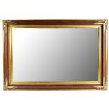 A modern gilt framed rectangular wall mirror with bevelled edge plate, 79 x 110cm.