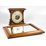 A Victorian carved oak aneroid barometer, 28cm high, with a walnut rectangular wall mirror (2)