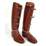 A pair of brown leather field boots, with buckled gaiter fronts and lace up lower sections, height