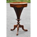 A Victorian octagonal walnut trumpet work table, with hinged top enclosing a fitted interior, on