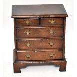 A small reproduction chest, of two short and three long drawers, on bracket feet, height 58cm, width