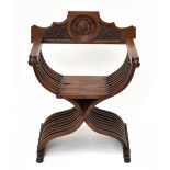 A Continental Savonarola type chair with carved crest and floral detail to back on shaped supports