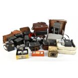 A miscellany of cameras including a Polaroid land camera model J66 with a leather case, a Polaroid