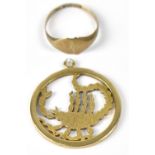 A 9ct gold pendant in the form of a scorpion within a circular mount,