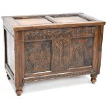 A late 17th century oak coffer chest with lift-up panelled top above carved frieze, dated 1681,