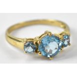 A 9ct yellow gold ring set with three topaz, size M, approx 1.9g.
