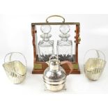 A 20th century wood and brass two-decanter tantalus containing two square pressed glass decanters