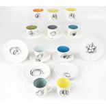 SUSIE COOPER; a part tea service of cream ground, with printed named fruits and coloured interiors,