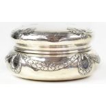 A late 19th/early 20th century French silver lidded dressing table jar of circular squat form,