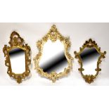 Three decorative modern wall mirrors in the antique style, each with scrolling borders of laurels,